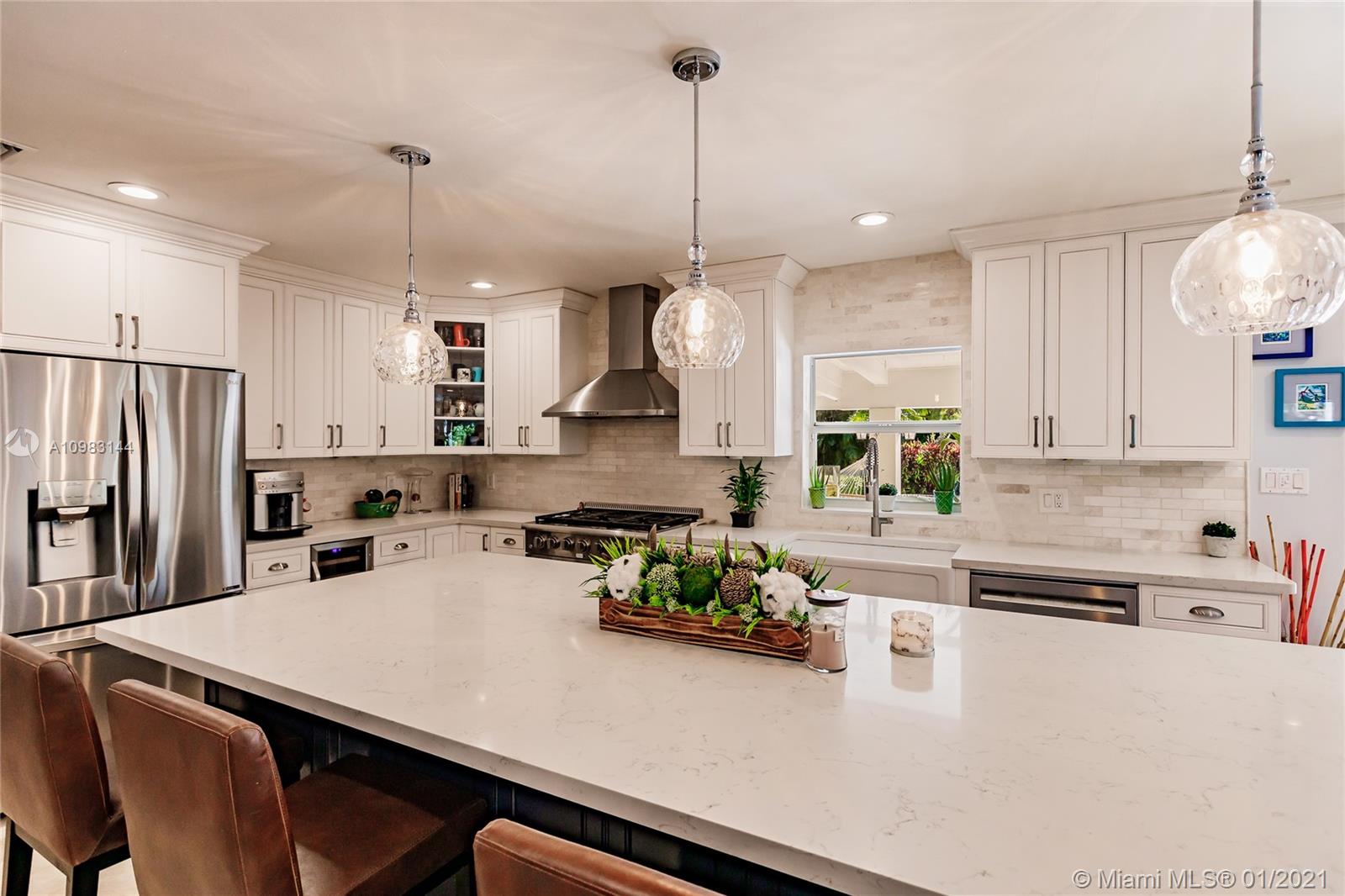 6400 Southwest 134th Drive Pinecrest, FL 33156 - Photo 18 of 50 a kitchen with a appliances a stove a sink a center island and cabinets