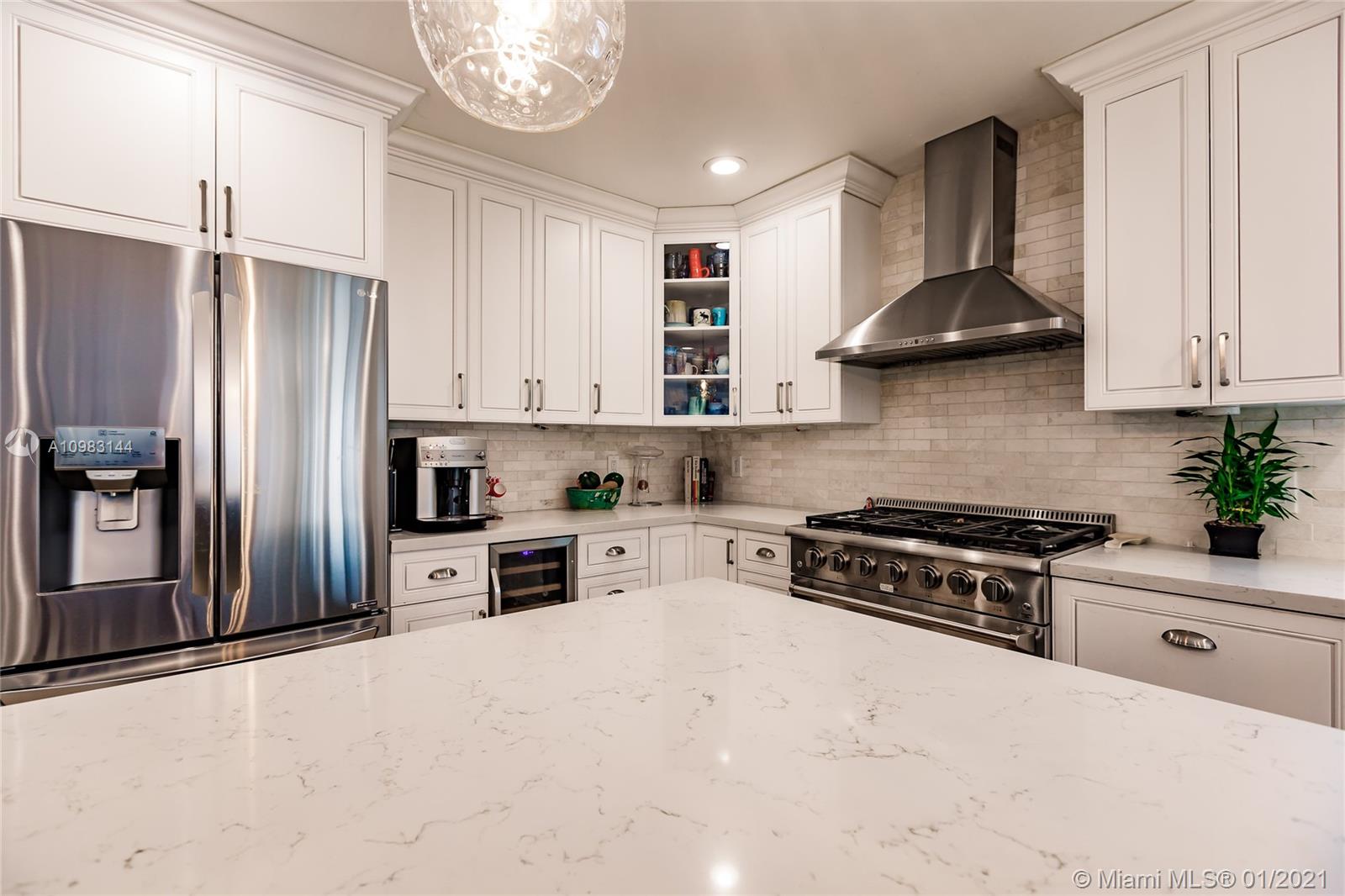 6400 Southwest 134th Drive Pinecrest, FL 33156 - Photo 19 of 50 a kitchen with stainless steel appliances granite countertop a stove a refrigerator and a sink
