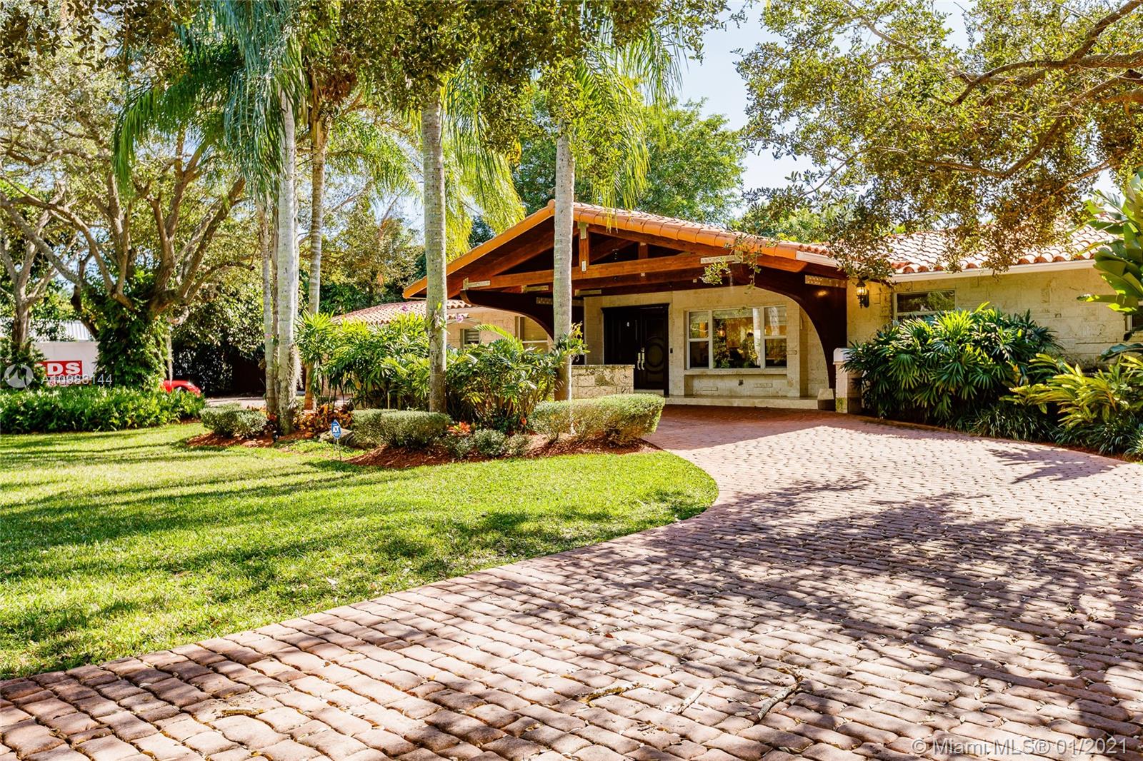 6400 Southwest 134th Drive Pinecrest, FL 33156 - Photo 3 of 50 a front view of a house with garden