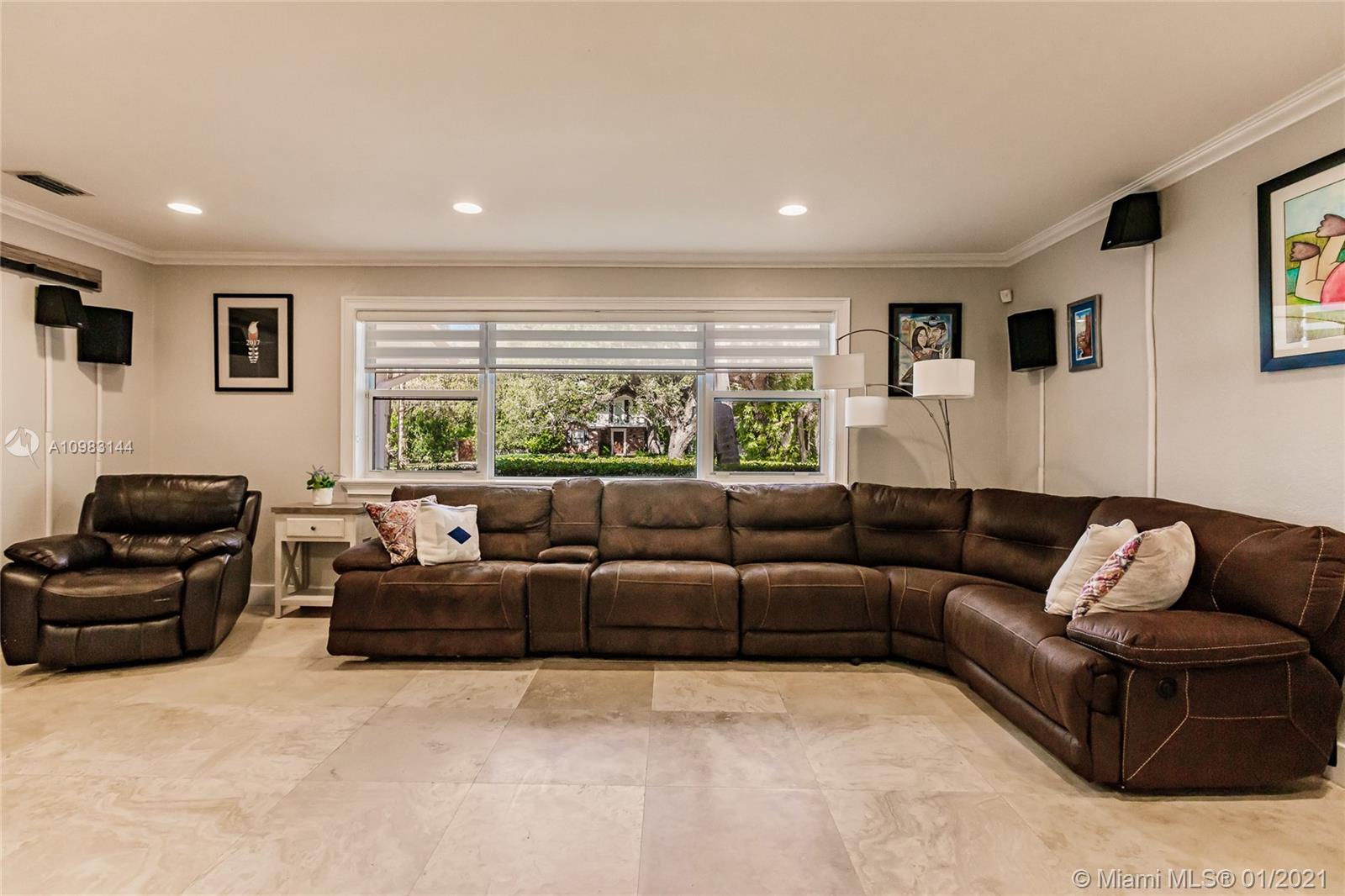 6400 Southwest 134th Drive Pinecrest, FL 33156 - Photo 22 of 50 a living room with furniture and a large window