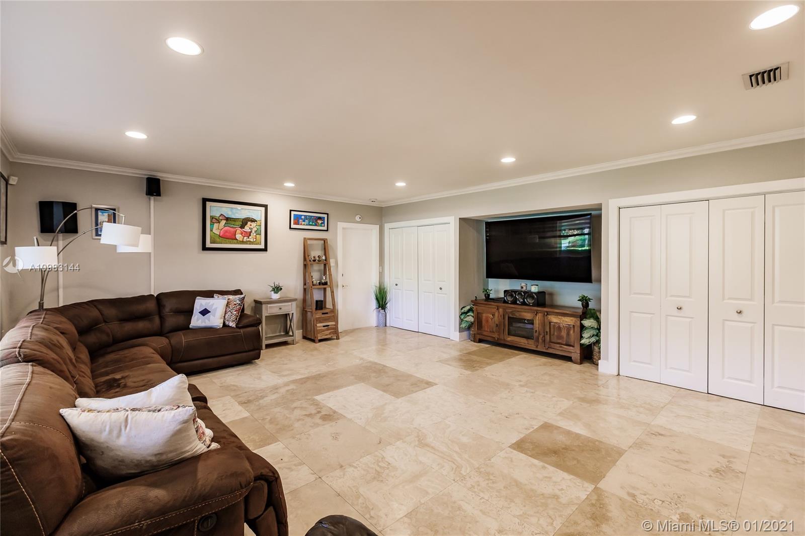6400 Southwest 134th Drive Pinecrest, FL 33156 - Photo 23 of 50 a living room with furniture and a flat screen tv