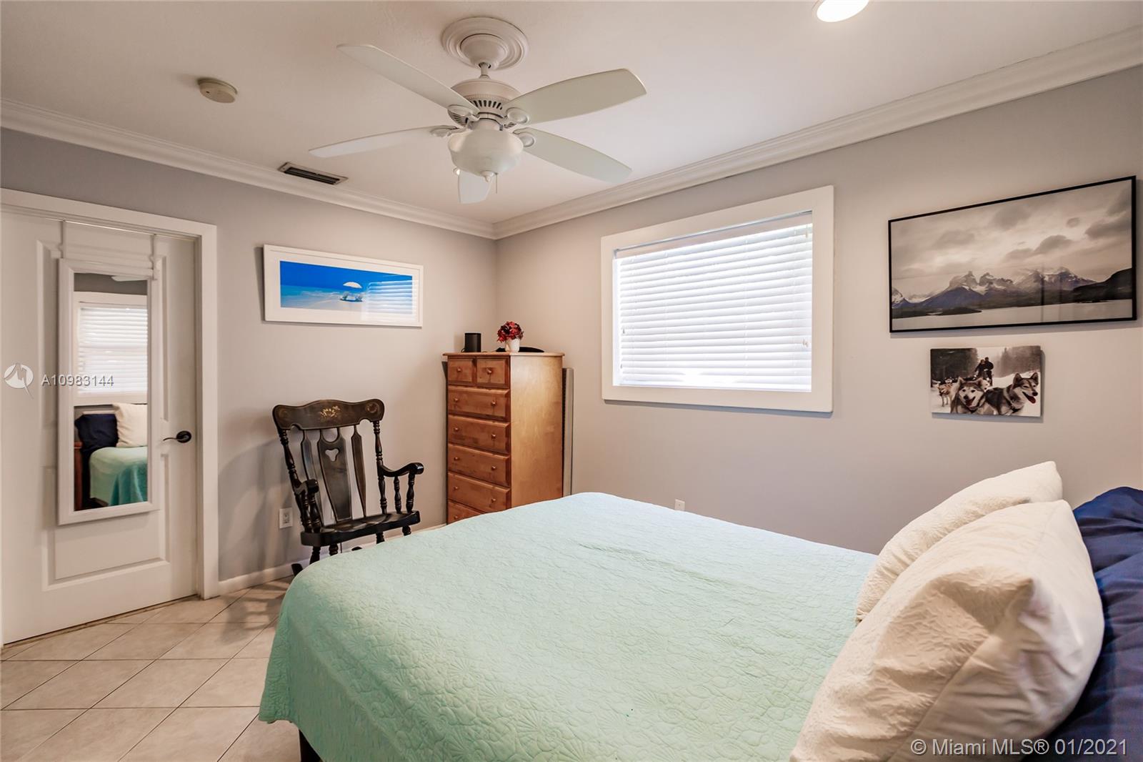 6400 Southwest 134th Drive Pinecrest, FL 33156 - Photo 29 of 50 a bedroom with a large bed and a chandelier