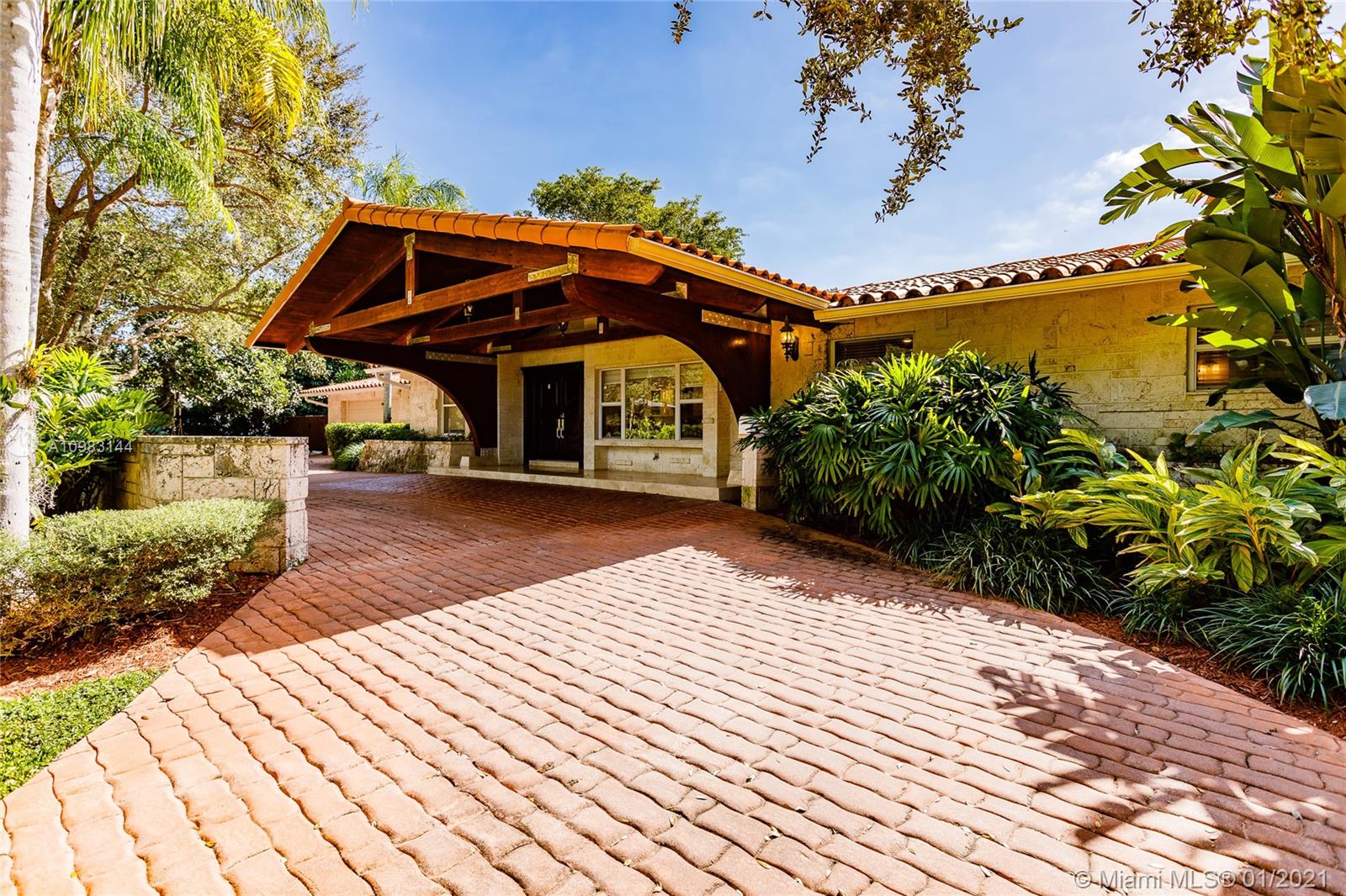6400 Southwest 134th Drive Pinecrest, FL 33156 - Photo 4 of 50 a front view of a house with a yard