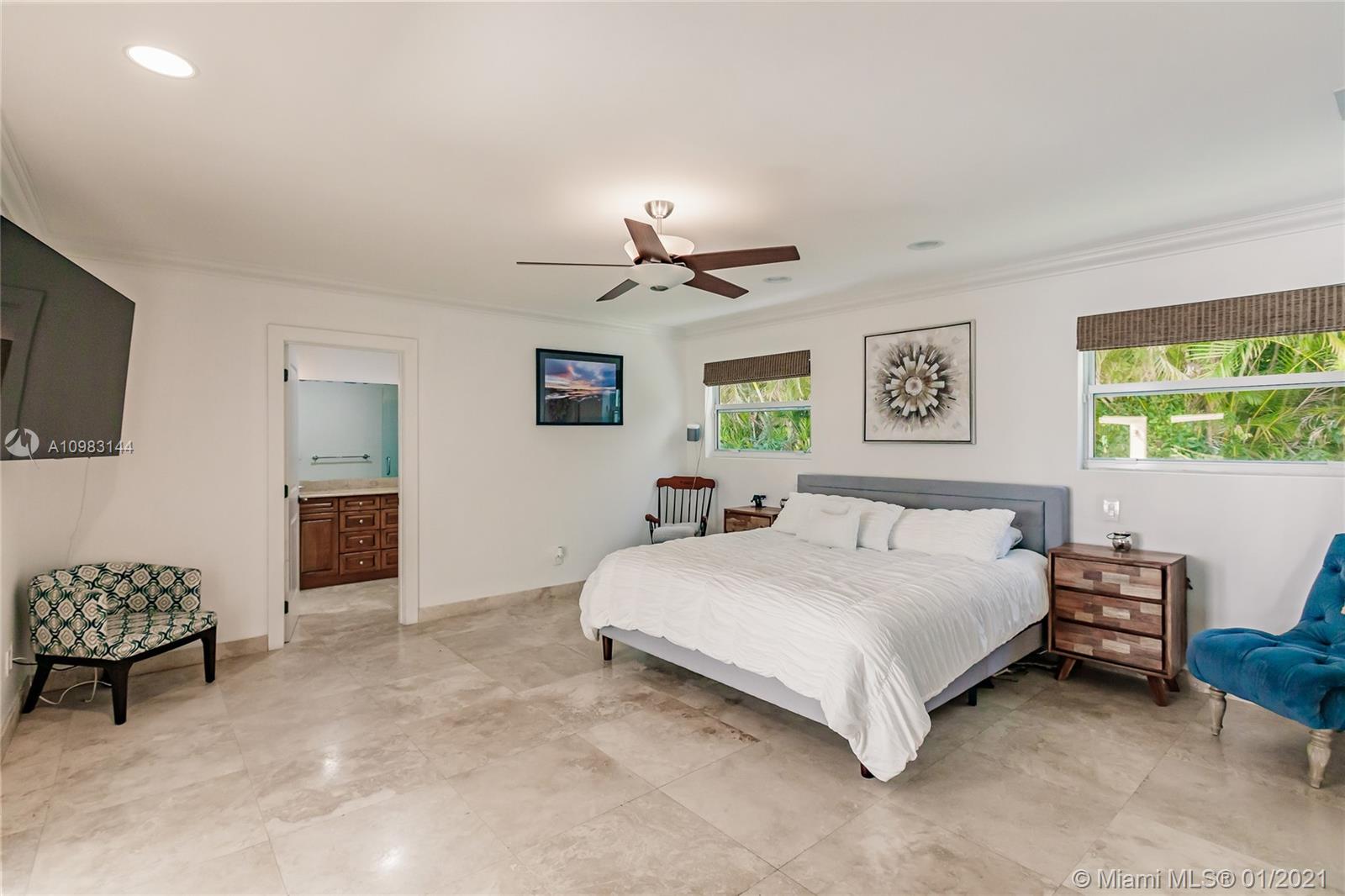 6400 Southwest 134th Drive Pinecrest, FL 33156 - Photo 33 of 50 a bedroom with a bed and a chandelier