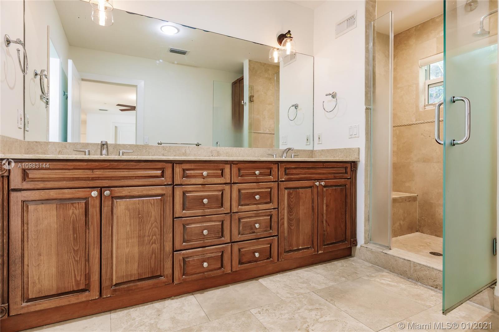 6400 Southwest 134th Drive Pinecrest, FL 33156 - Photo 36 of 50 a spacious bathroom with a granite countertop sink and a mirror