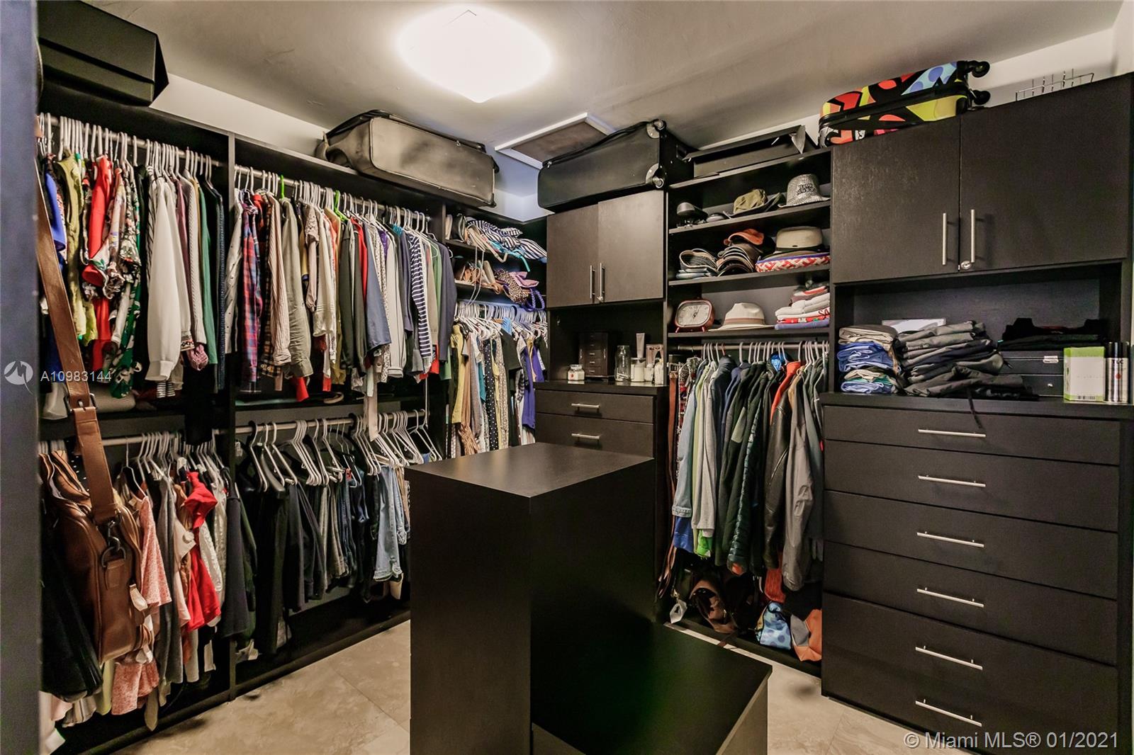 6400 Southwest 134th Drive Pinecrest, FL 33156 - Photo 38 of 50 a view of walk in closet with clothes and shoes