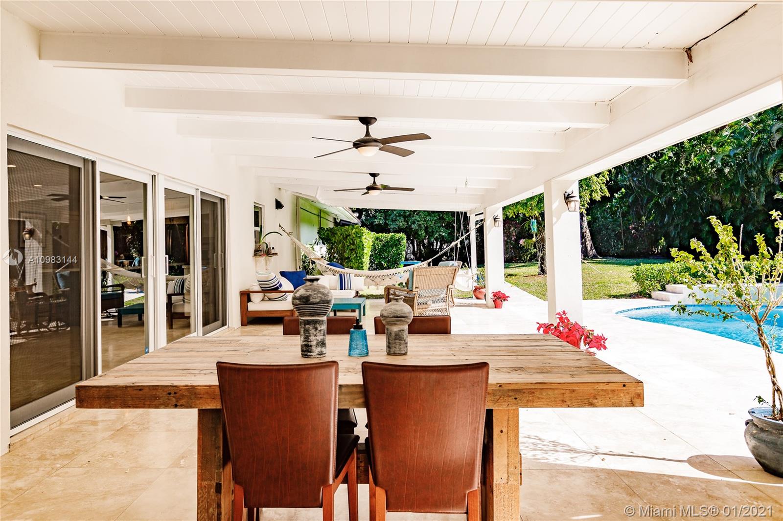 6400 Southwest 134th Drive Pinecrest, FL 33156 - Photo 41 of 50 a view of a patio with a dining table and chairs