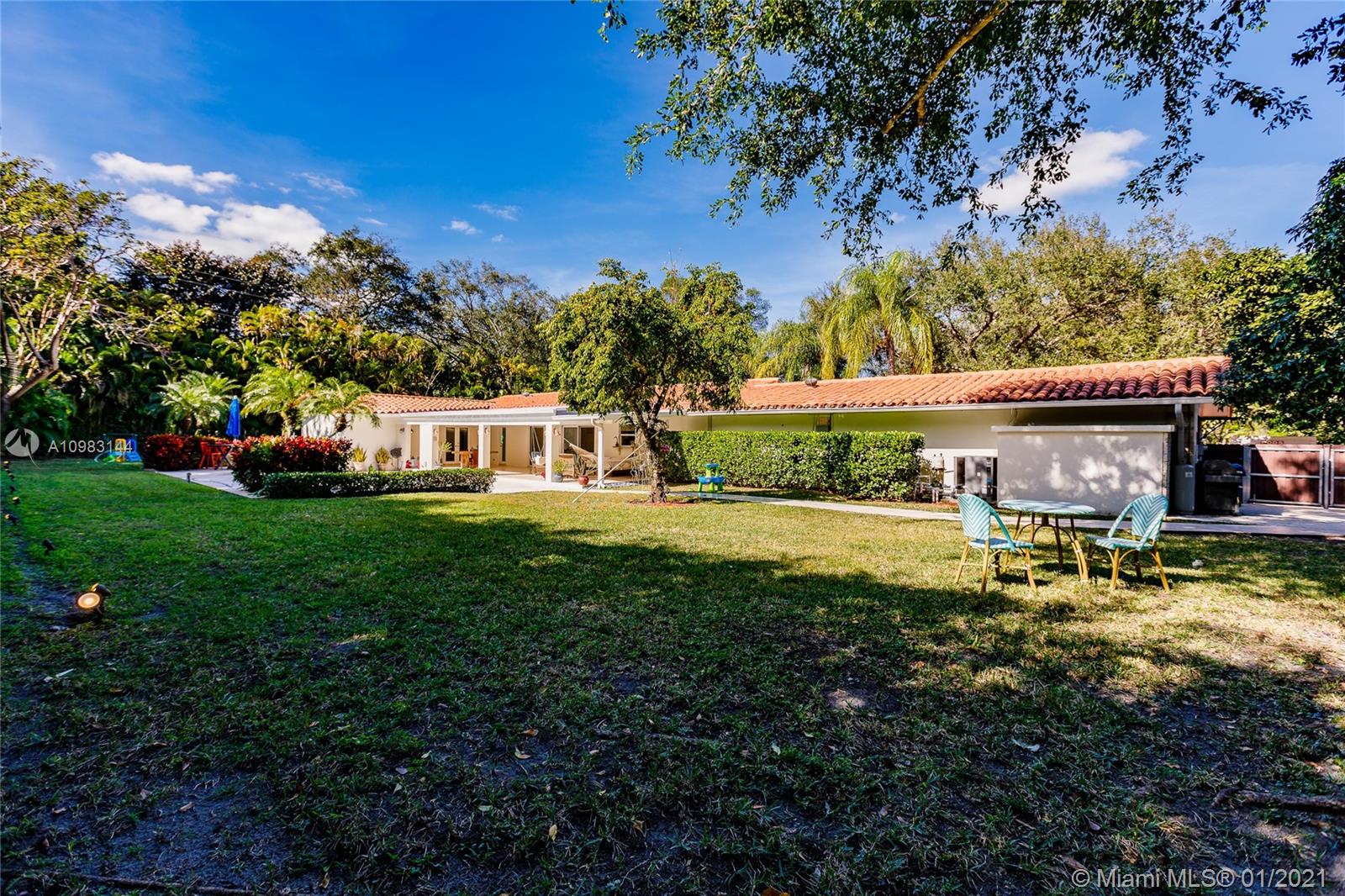 6400 Southwest 134th Drive Pinecrest, FL 33156 - Photo 47 of 50 a view of house with outdoor space and garden
