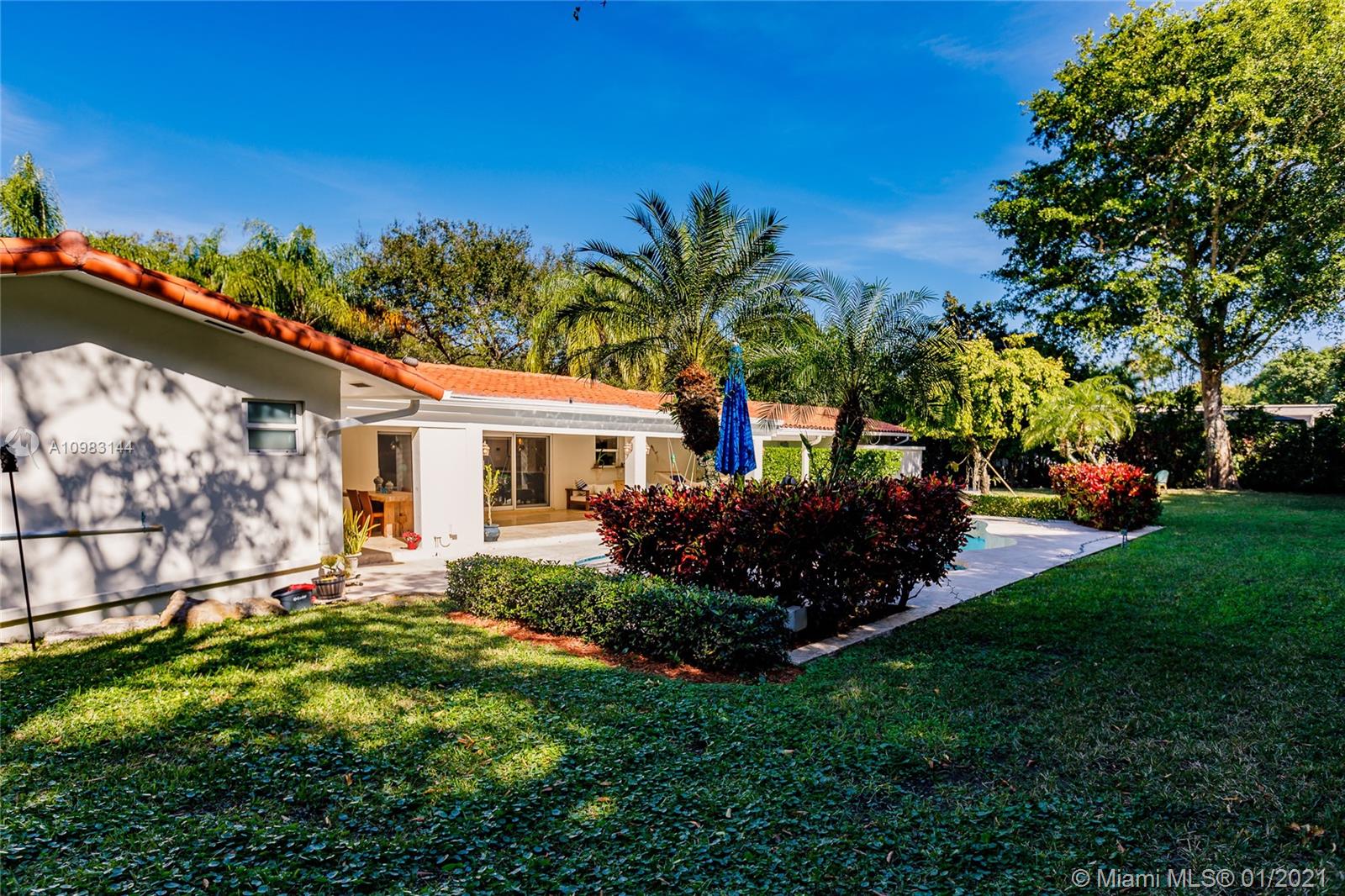 6400 Southwest 134th Drive Pinecrest, FL 33156 - Photo 48 of 50 a front view of a house with a garden