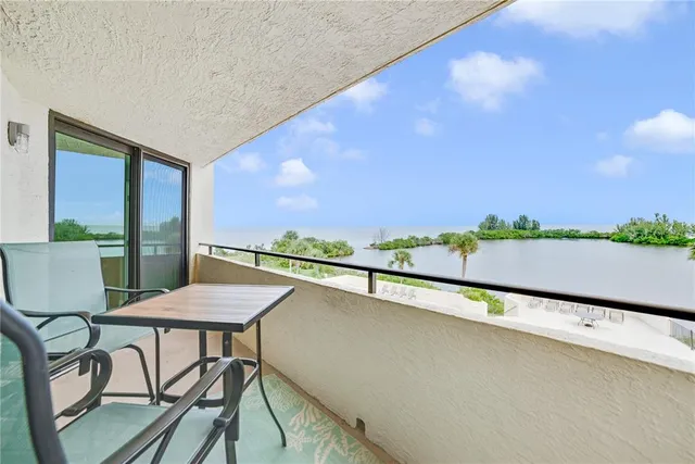 a view of a chairs and table in patio