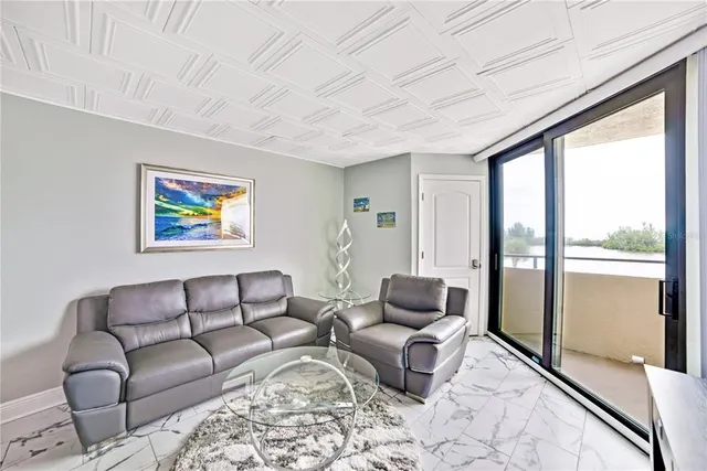 a living room with furniture and a floor to ceiling window