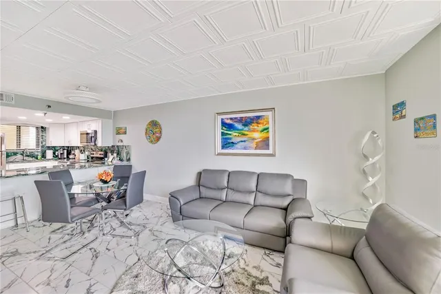 a living room with furniture and kitchen view