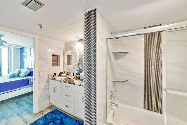 a bathroom with a double vanity sink mirror and shower