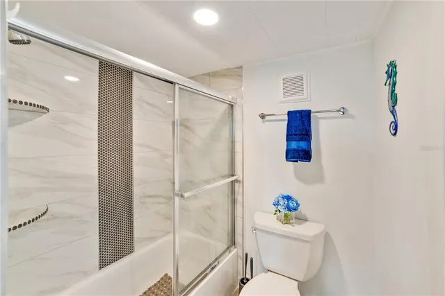 a bathroom with a sink mirror vanity and toilet