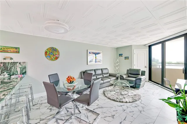 a living room with furniture a rug and a table