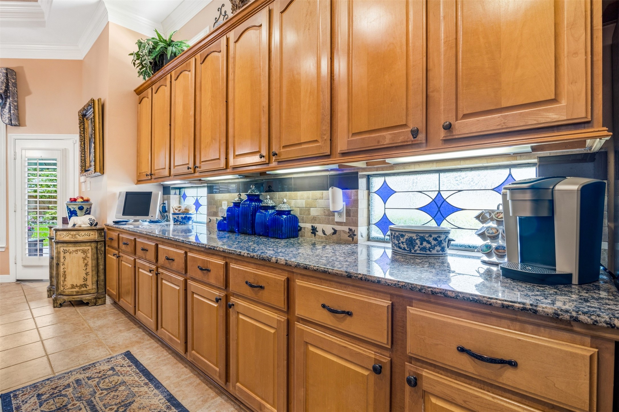 12215 Pebble Meadows Houston, TX 77041 - Photo 12 of 44 Kitchen features granite countertops with tile backsplash and under cabinet lighting.