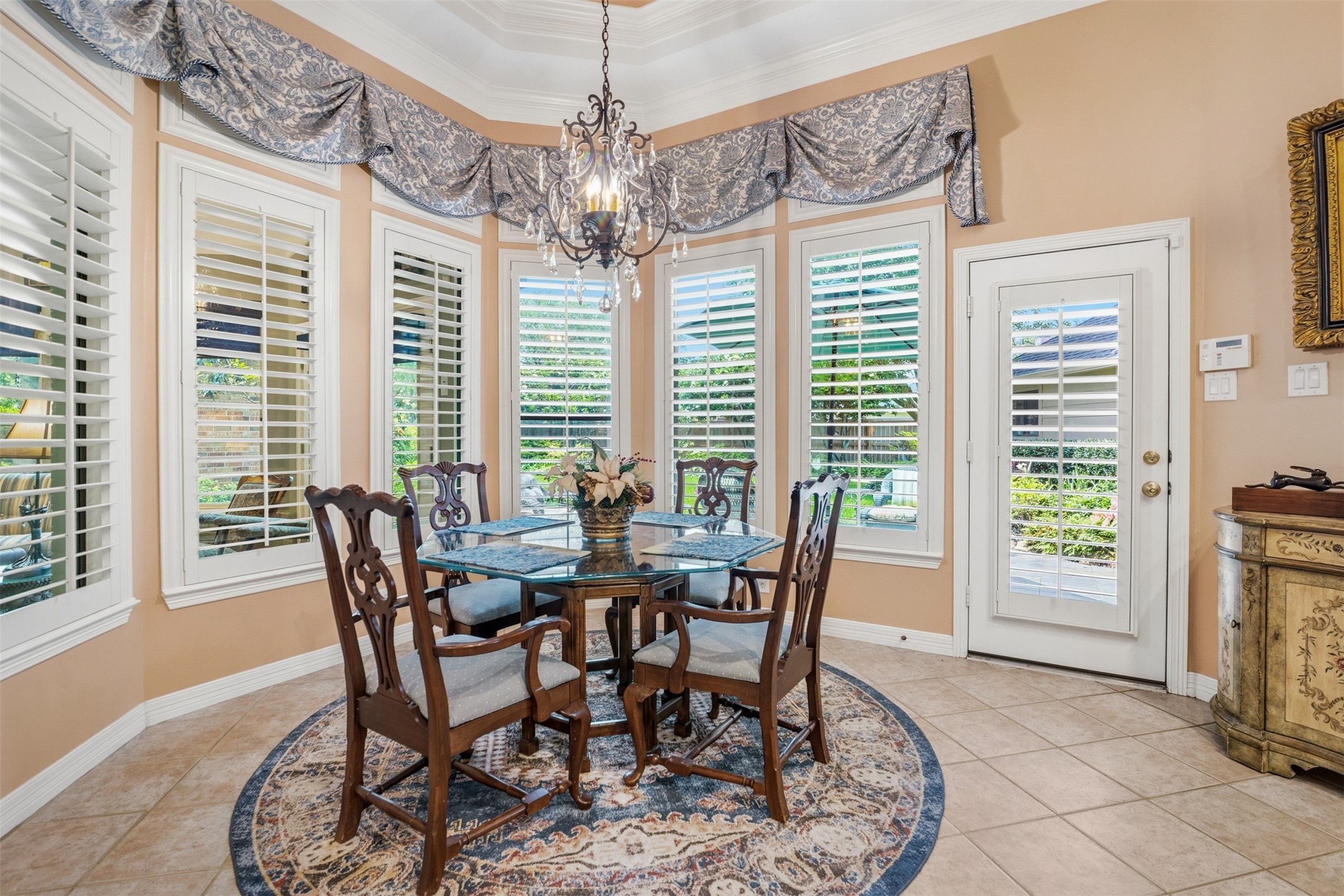 12215 Pebble Meadows Houston, TX 77041 - Photo 14 of 44 The breakfast room is encompassed with wall of windows with shutters overlooking the backyard.