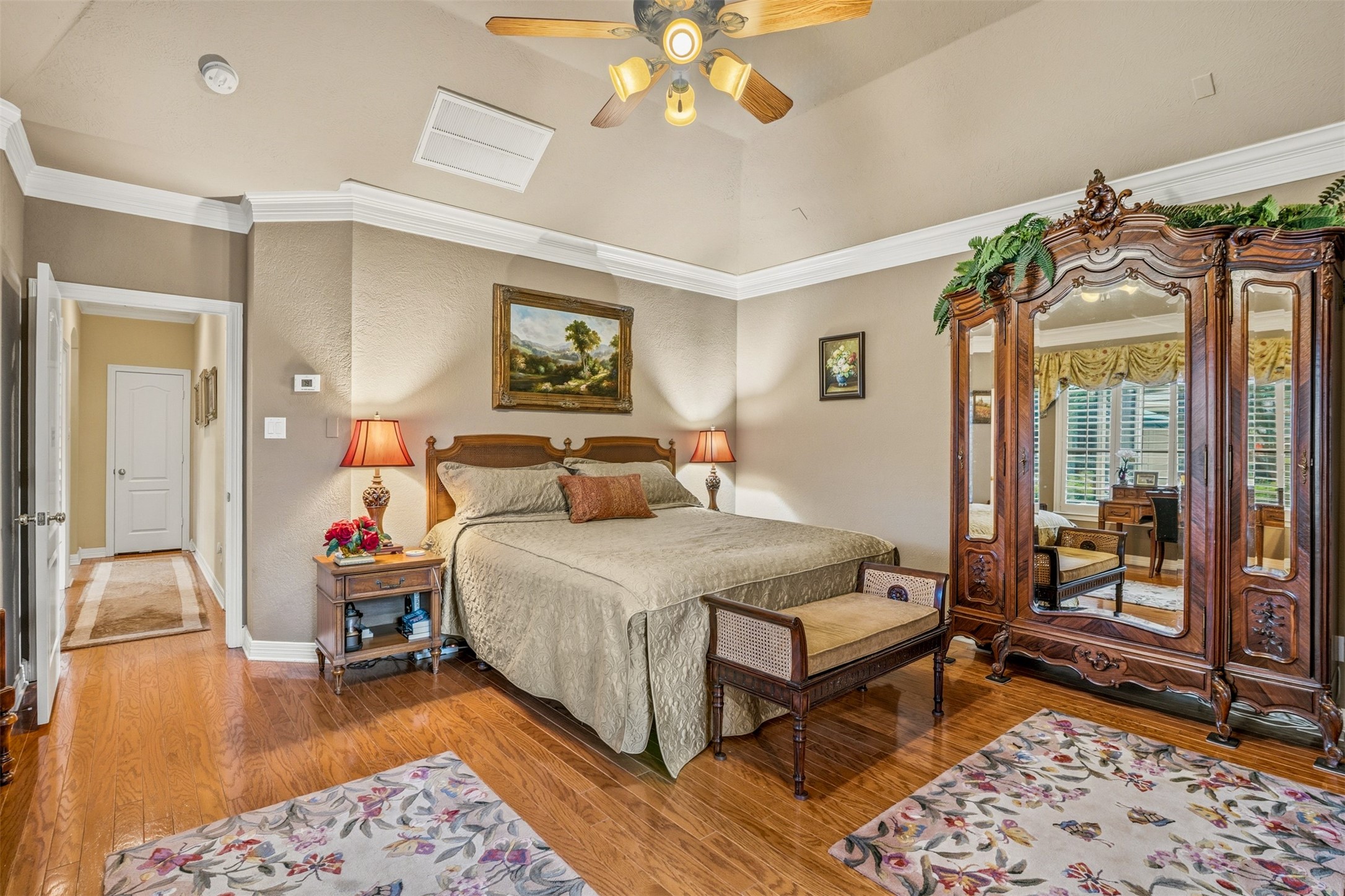 12215 Pebble Meadows Houston, TX 77041 - Photo 15 of 44 The primary bedroom is your own private retreat with wood floors, elevated ceiling with fan and crown molding.