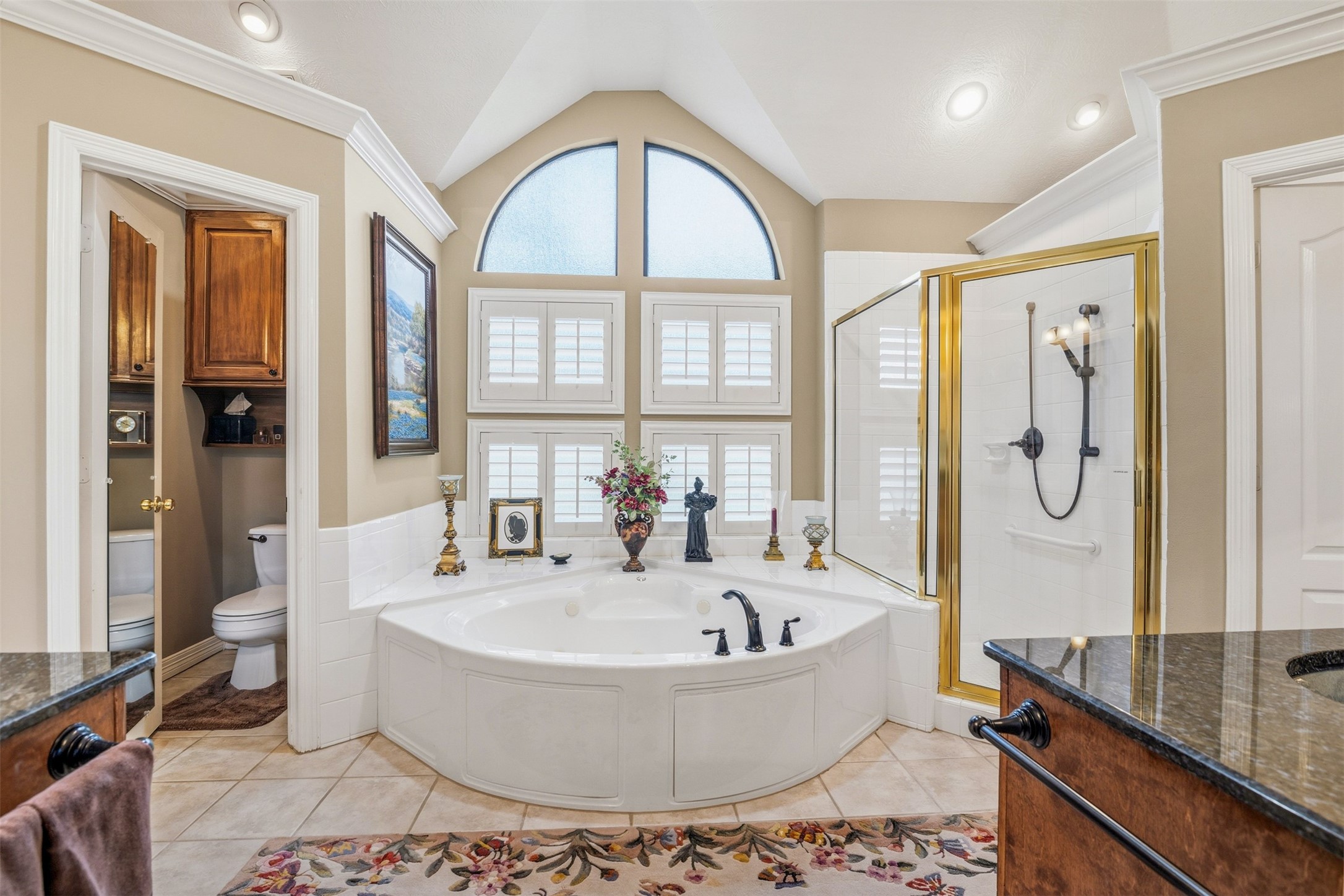 12215 Pebble Meadows Houston, TX 77041 - Photo 17 of 44 The primary bathroom features a large jetted tub and separate spacious walk in glass frame shower.