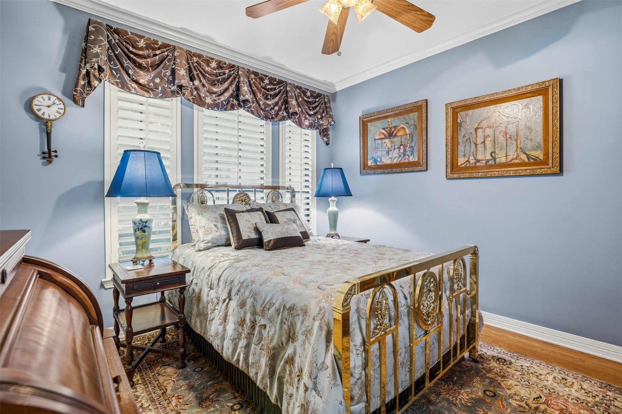 12215 Pebble Meadows Houston, TX 77041 - Photo 19 of 44 Secondary bedroom with wood floors, ceiling fan, crown molding and windows with shutters.