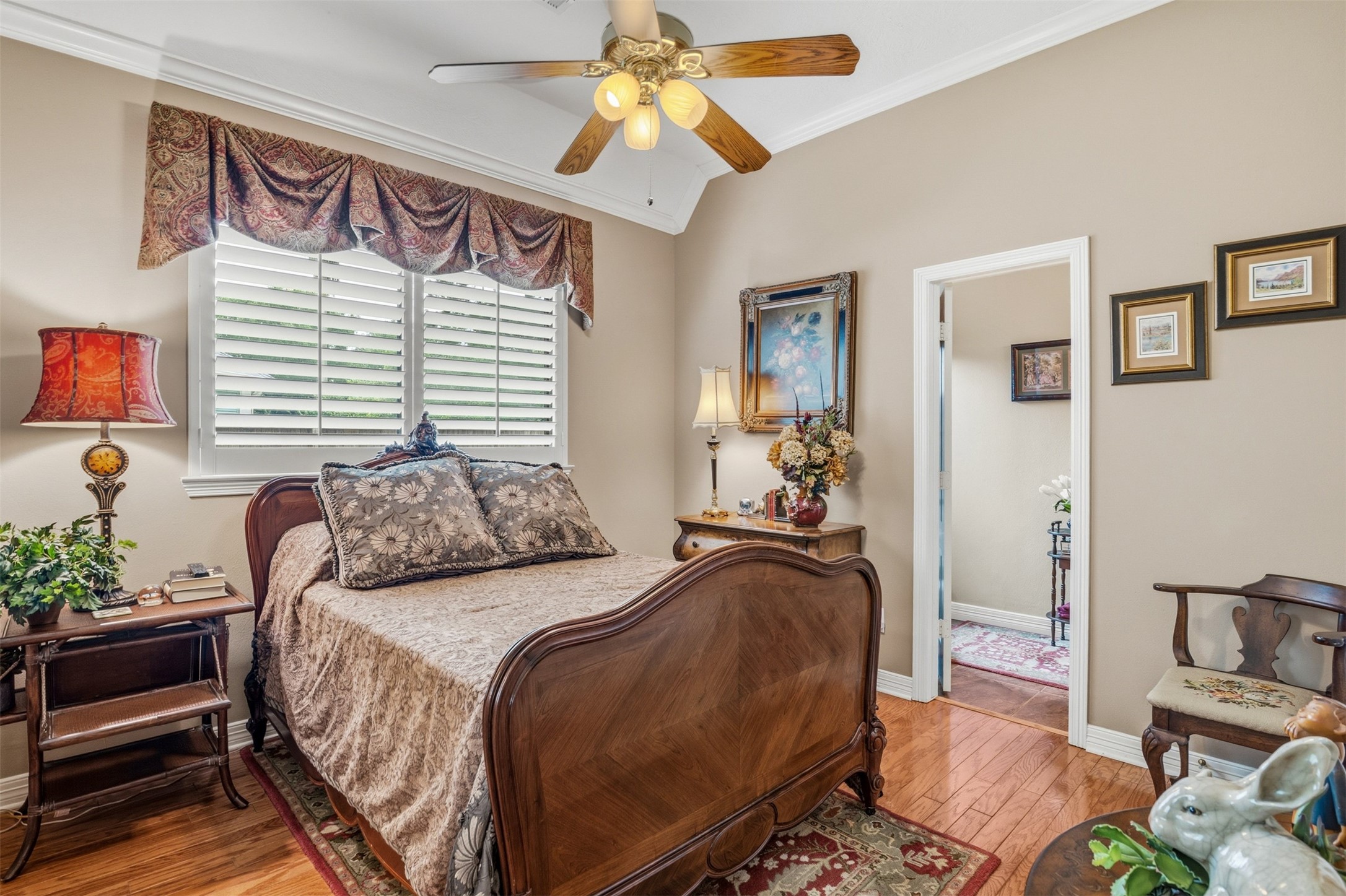 12215 Pebble Meadows Houston, TX 77041 - Photo 20 of 44 Another secondary bedroom with wood floors, ceiling fan, crown molding and large picture window with shutters. The room also features an ensuite bathroom.