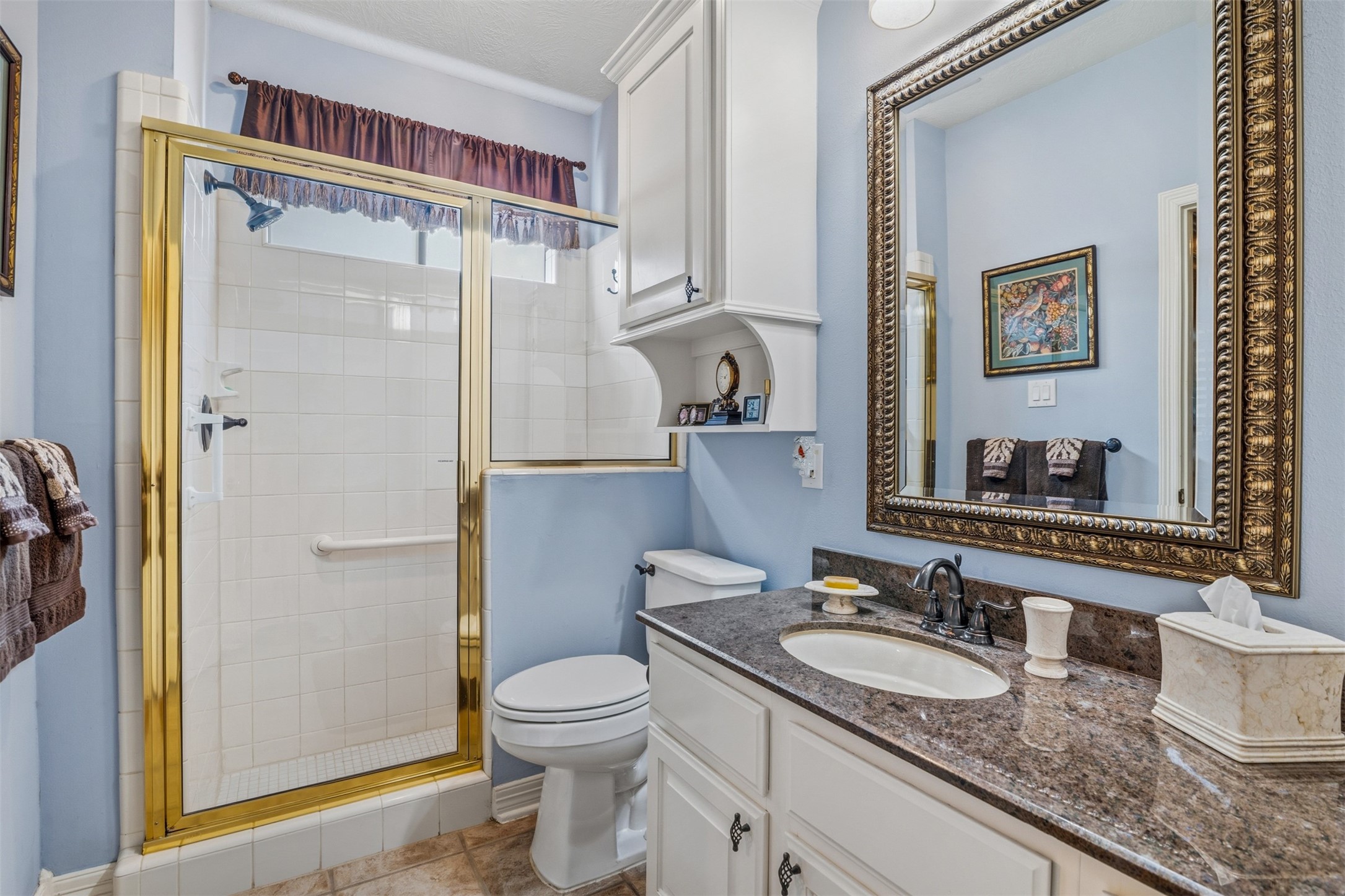 12215 Pebble Meadows Houston, TX 77041 - Photo 22 of 44 Another secondary full bathroom with a single sink vanity with granite countertops and a glass frame walk in shower.