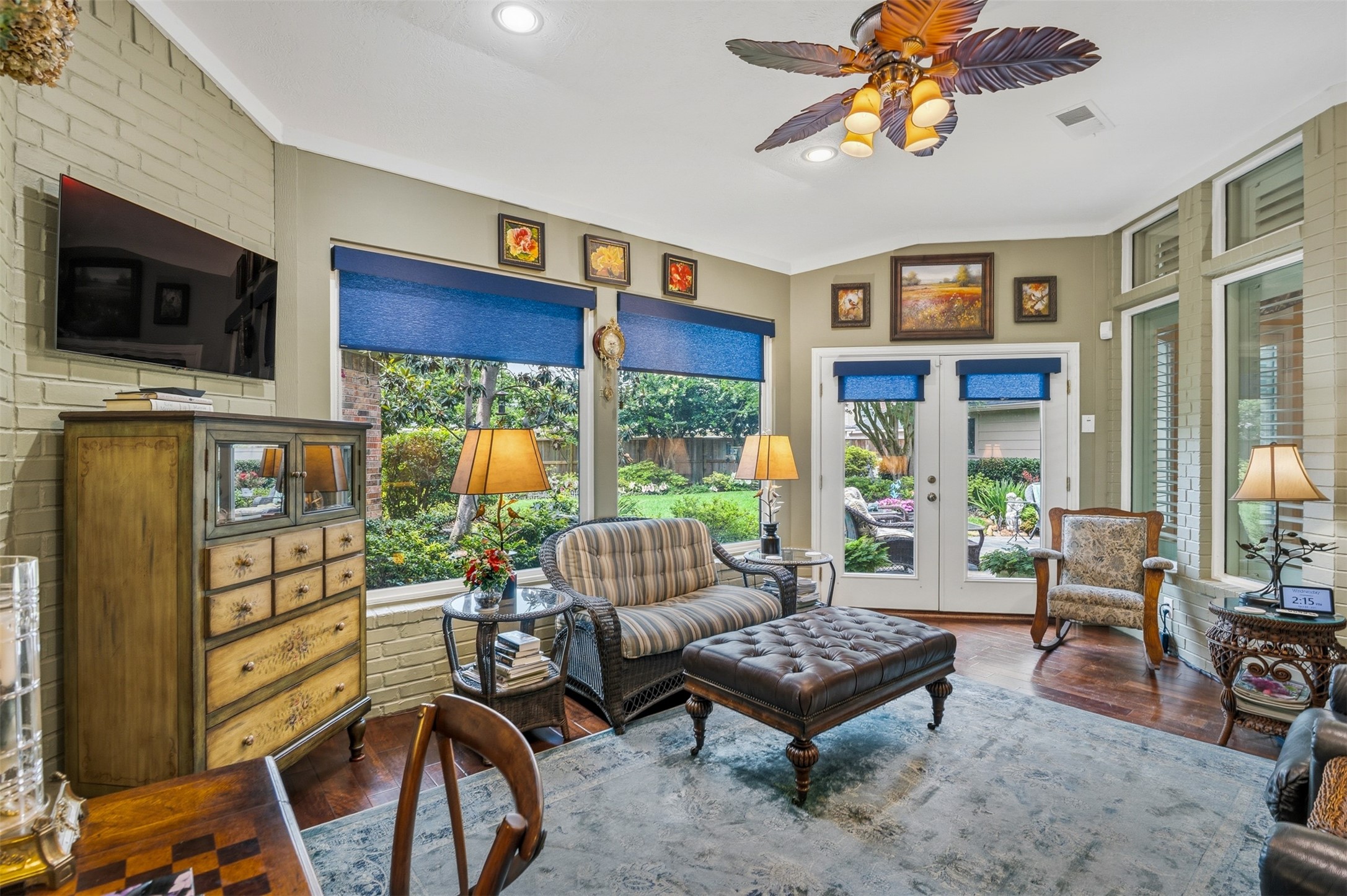 12215 Pebble Meadows Houston, TX 77041 - Photo 24 of 44 The sunroom also features a ceiling fan, wood floors and double doors leading to the backyard.