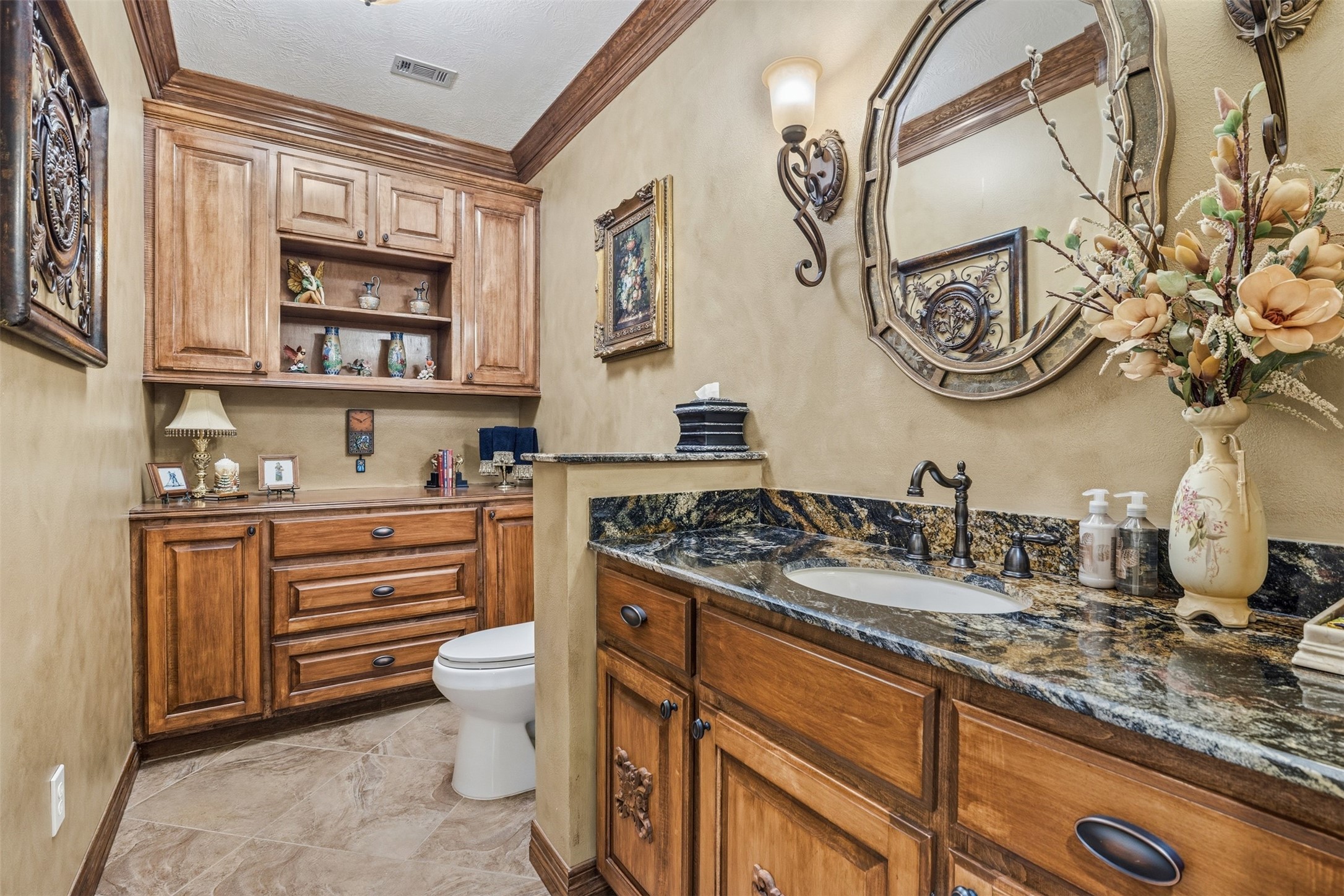 12215 Pebble Meadows Houston, TX 77041 - Photo 27 of 44 The half bath features more custom built ins for storage and single sink vanity with granite countertop.