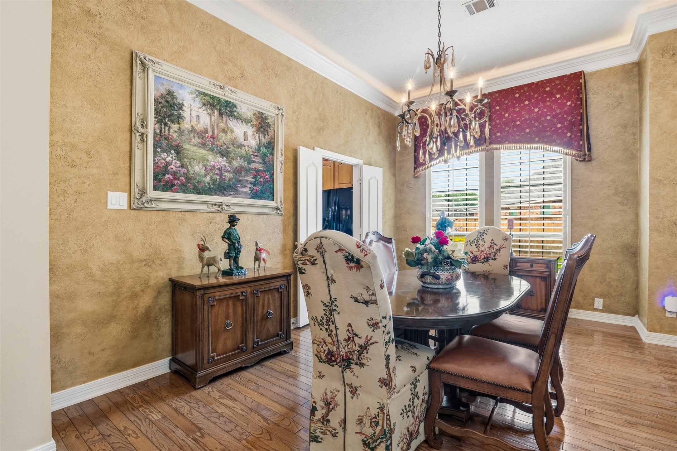 12215 Pebble Meadows Houston, TX 77041 - Photo 7 of 44 The dining room features wood floors, large picture windows with shutters and cove lighting.