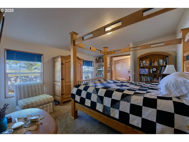 a bedroom with a bed and glass window