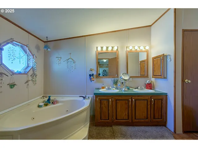 a bathroom with a sink mirror and a bathtub