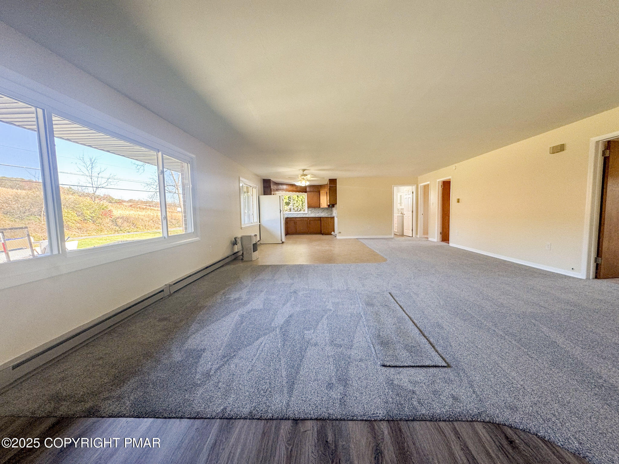 1350 Kunkletown Road Saylorsburg, PA 18353 - Photo 4 of 15 a view of an empty room with a window and wooden floor