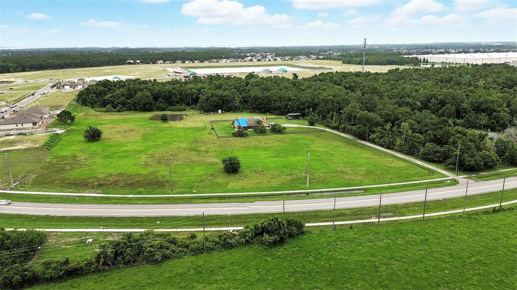 2481 Ham Brown Road Kissimmee, FL 34746 - Photo 3 of 28 a view of a swimming pool with a garden