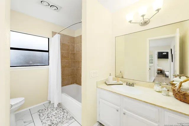 a bedroom with a bed and a white wall