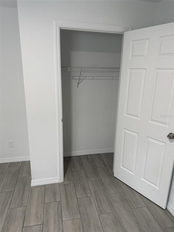 89 West Imogene Street Arcadia, FL 34266 - Photo 11 of 18 a view of an empty room with closet and wooden floor