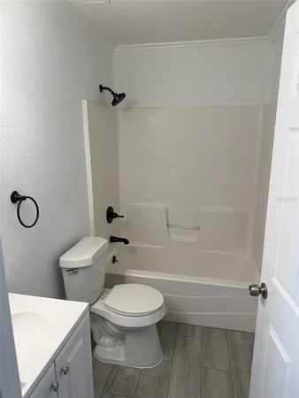 a bathroom with a toilet a sink and shower