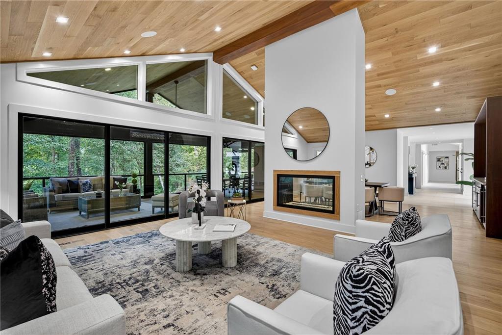 585 Amberidge Trail Northwest Atlanta, GA 30328 - Photo 15 of 103 a living room with furniture a large window and a fireplace
