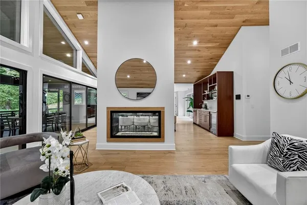 a very nice looking dining room with a large window and a fireplace