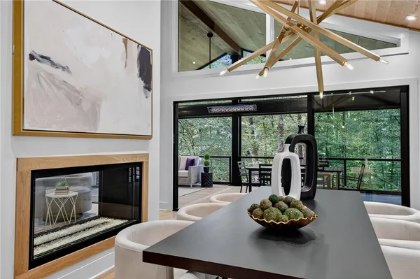 a kitchen with stainless steel appliances granite countertop a table chairs and a refrigerator