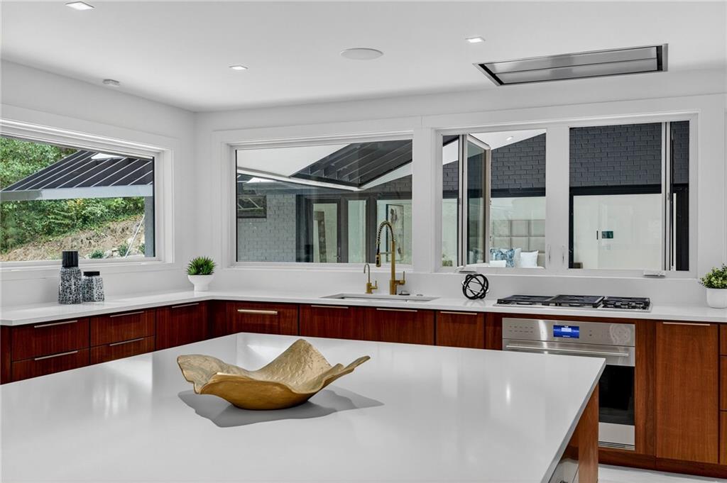 585 Amberidge Trail Northwest Atlanta, GA 30328 - Photo 28 of 85 a large white kitchen with a large window and stainless steel appliances