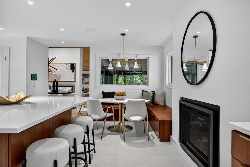 585 Amberidge Trail Northwest Atlanta, GA 30328 - Photo 30 of 103 a very nice looking dining room with a large window and a fireplace