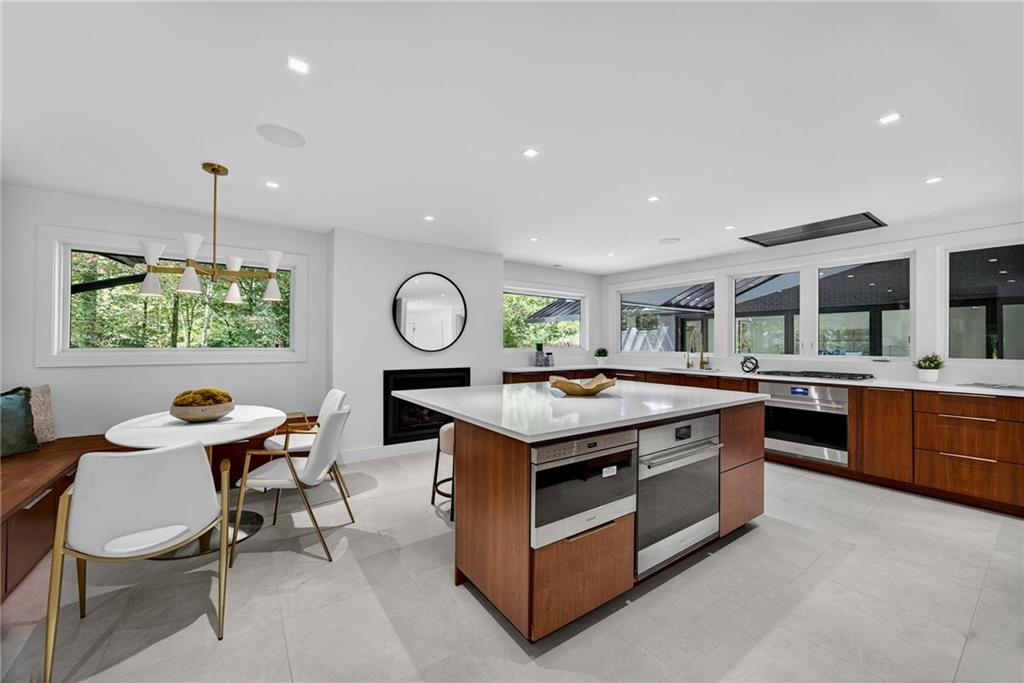585 Amberidge Trail Northwest Atlanta, GA 30328 - Photo 40 of 103 a kitchen with stainless steel appliances granite countertop a stove and a sink