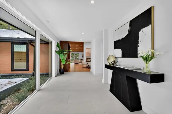 a living room with furniture a flat screen tv and a window
