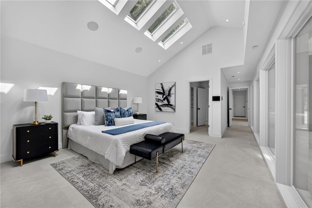 585 Amberidge Trail Northwest Atlanta, GA 30328 - Photo 43 of 103 a bedroom with a bed and lamp on desk