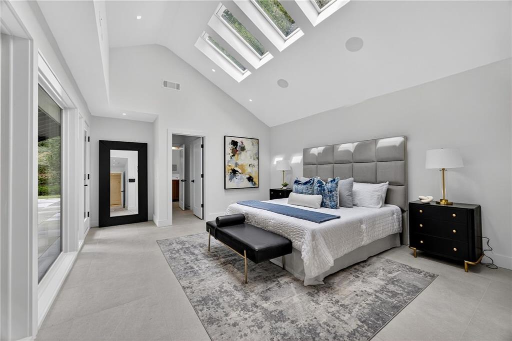 585 Amberidge Trail Northwest Atlanta, GA 30328 - Photo 44 of 103 a bedroom with a bed and a large mirror