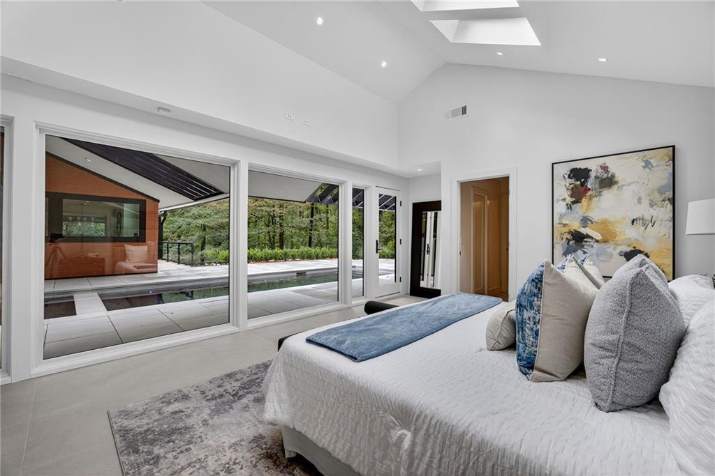 585 Amberidge Trail Northwest Atlanta, GA 30328 - Photo 45 of 103 a bedroom with a large bed and a large window