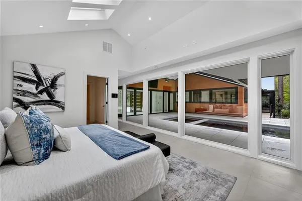 a media room with lots of furniture and a large window