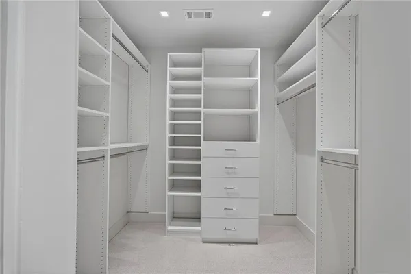 a front view of house with yard and trees in the background