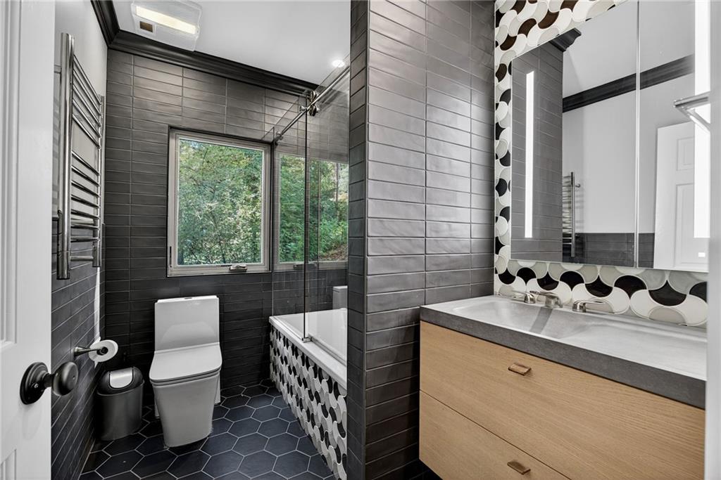 585 Amberidge Trail Northwest Atlanta, GA 30328 - Photo 51 of 85 a bathroom with a sink toilet and shower