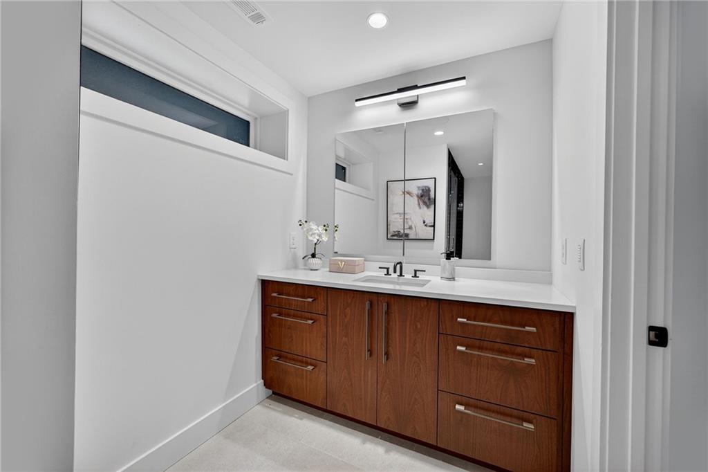 585 Amberidge Trail Northwest Atlanta, GA 30328 - Photo 53 of 85 a bathroom with a double vanity sink and a mirror